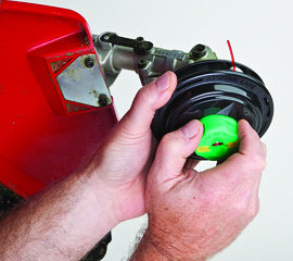 Hold drum securely and turn spool with direction of arrow until remaining line retracts fully into drum.